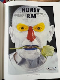 an open book with an image of a clown with a flower in his mouth