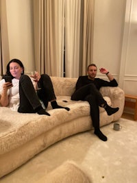 two people sitting on a couch in a living room