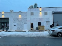 a car is parked in front of a white building