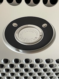 a close up of a circular metal plate with holes in it