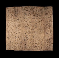 a brown piece of cloth with writing on it